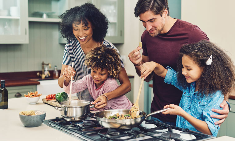 Happy family using Hometown Heating Propane to cook dinner